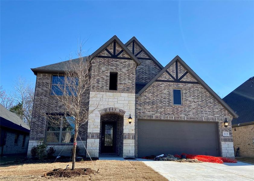 Gorgeous Stone & brick home with inlaid cedar backs to lots of trees!