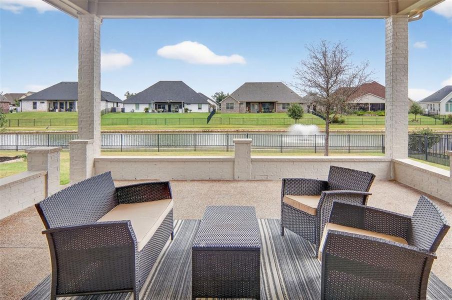 View of patio with a residential view and a water view