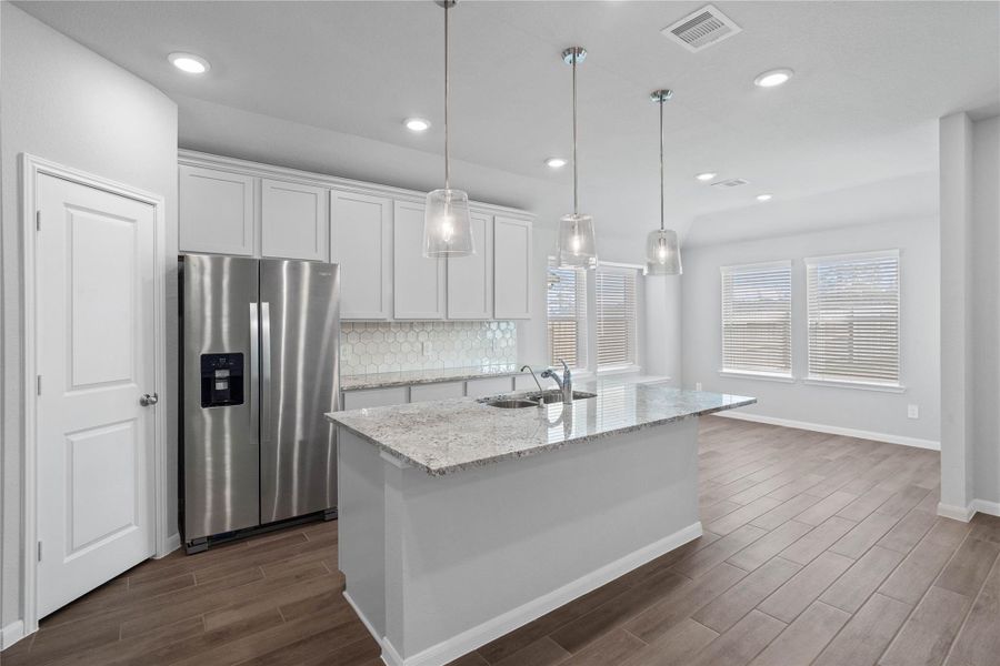 The kitchen island provides a convenient breakfast bar, perfect for casual dining and or long conversations.