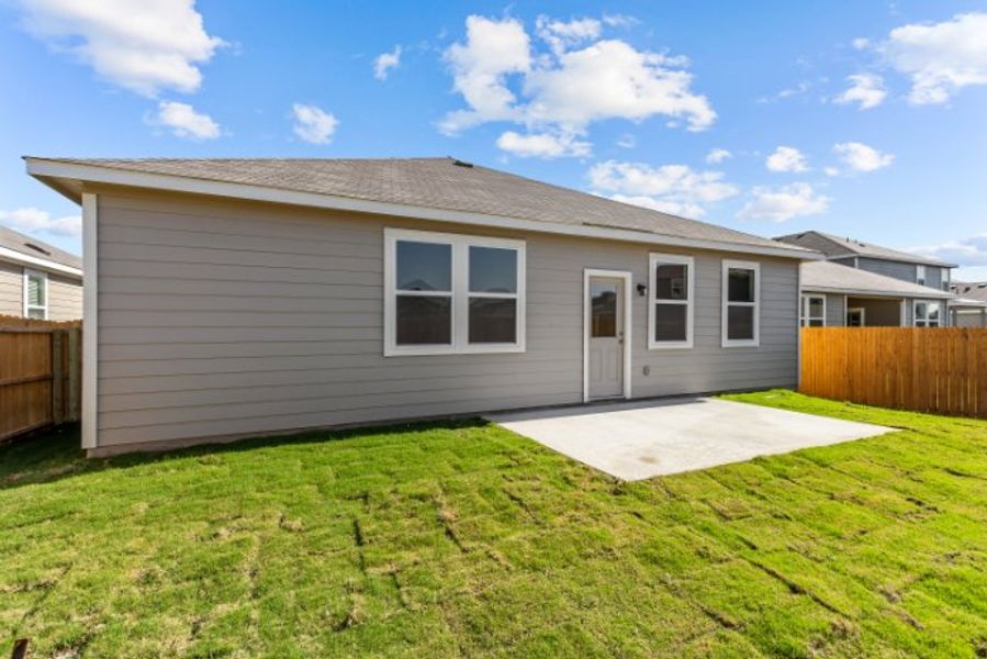 A house with a fence and grass.