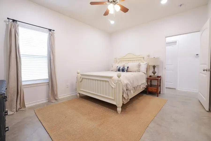 Bedroom with ceiling fan and recessed lighting