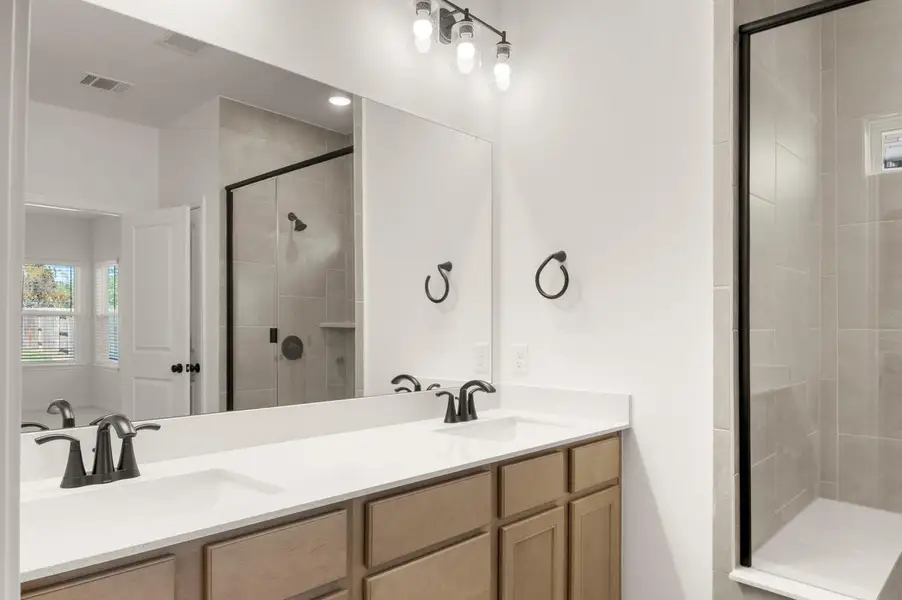 Bathroom with a shower stall, double vanity, and a bathtub Bathroom with a shower stall, double vanity, and a bathtub