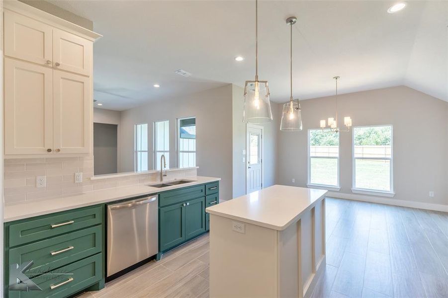Kitchen with green cabinets, dishwasher, light countertops, decorative backsplash, and recessed lighting