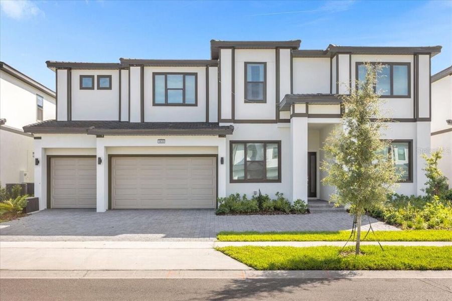 Front exterior of a new home in Paradiso Grande Resort, Orlando, FL, highlighting curb appeal (Image 1). Front exterior of a new home in Paradiso Grande Resort, Orlando, FL, highlighting curb appeal (Image 1).