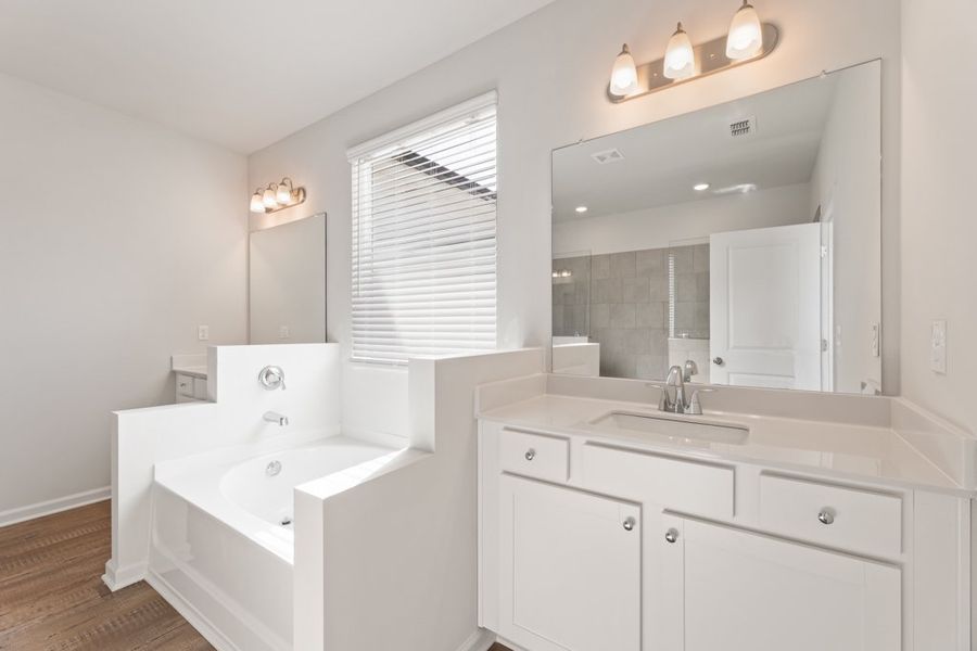 A bathroom with a large mirror.