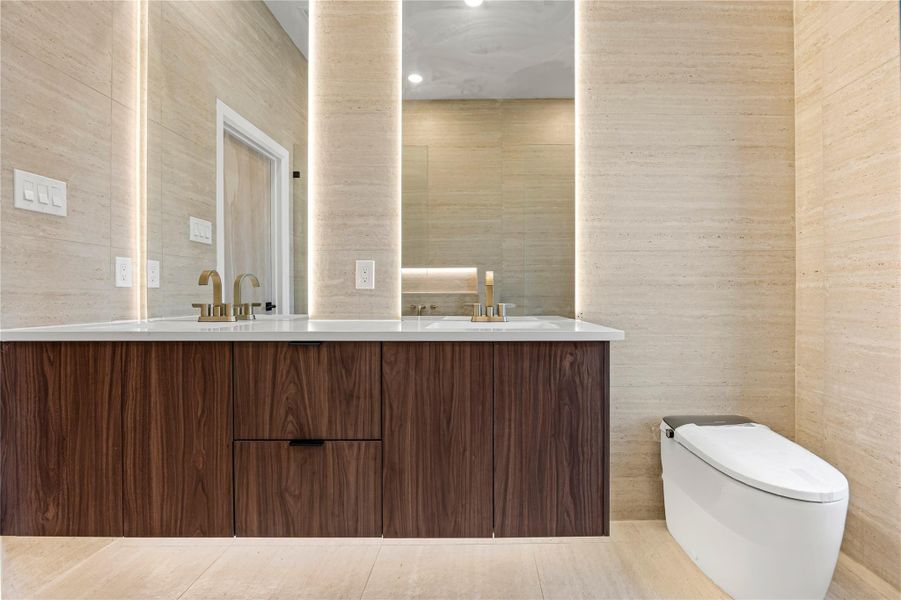 Full bathroom featuring double vanity, light tile patterned floors, recessed lighting, and tile walls
