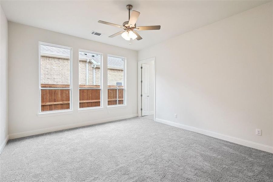 Empty room with carpet flooring and ceiling fan