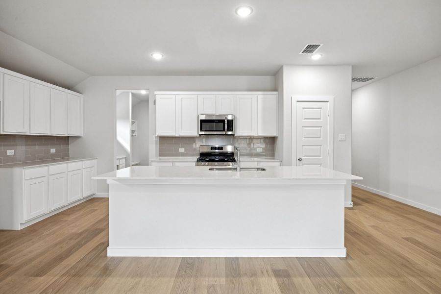 Kitchen in the Heisman home plan by Trophy Signature Homes – REPRESENTATIVE PHOTO