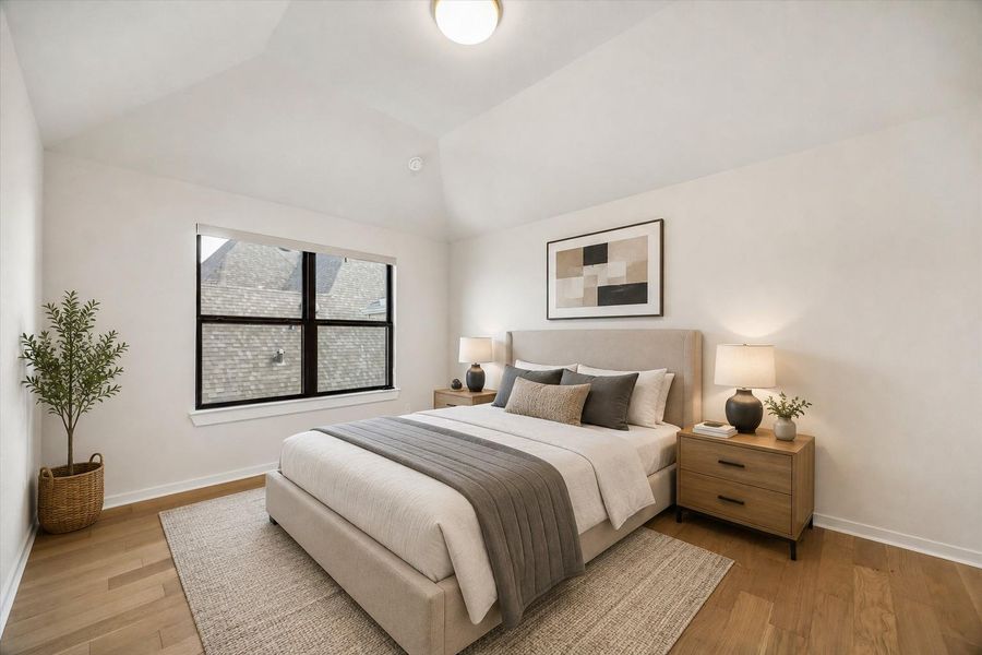 BEDROOM 4 FEATURES A VAULTED CEILING, WOOD FLOORING, AND A LARGE BLACK-FRAMED WINDOW THAT BRINGS IN NATURAL LIGHT. **Virtually Staged. BEDROOM 4 FEATURES A VAULTED CEILING, WOOD FLOORING, AND A LARGE BLACK-FRAMED WINDOW THAT BRINGS IN NATURAL LIGHT. **Virtually Staged.