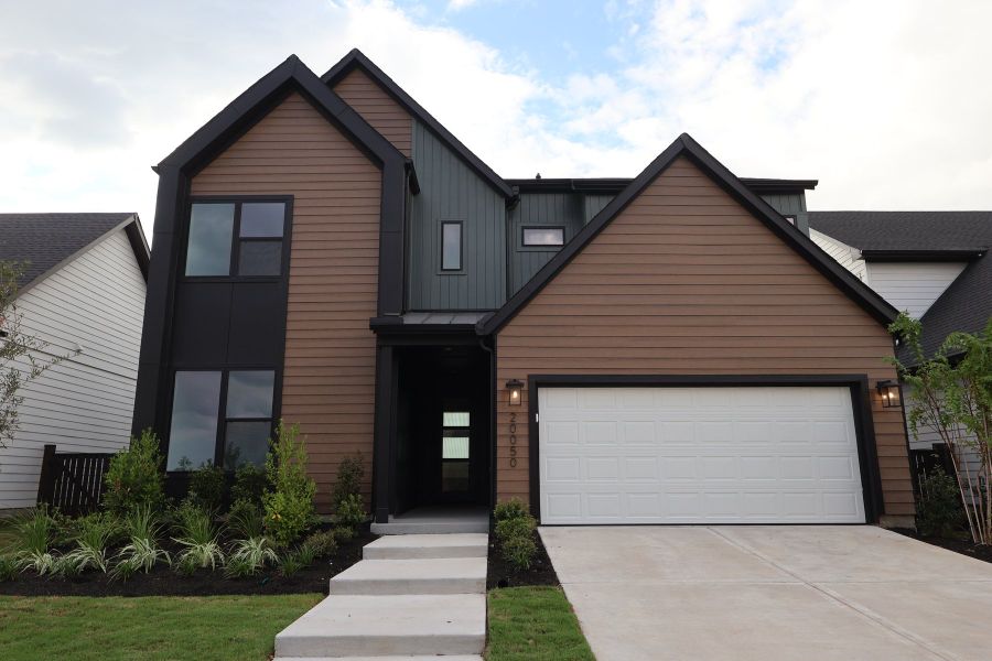 Front exterior of a new home in Bridgeland Central: Emerald Heights - Enclave Collection, Cypress, TX, highlighting curb appeal (Image 2).