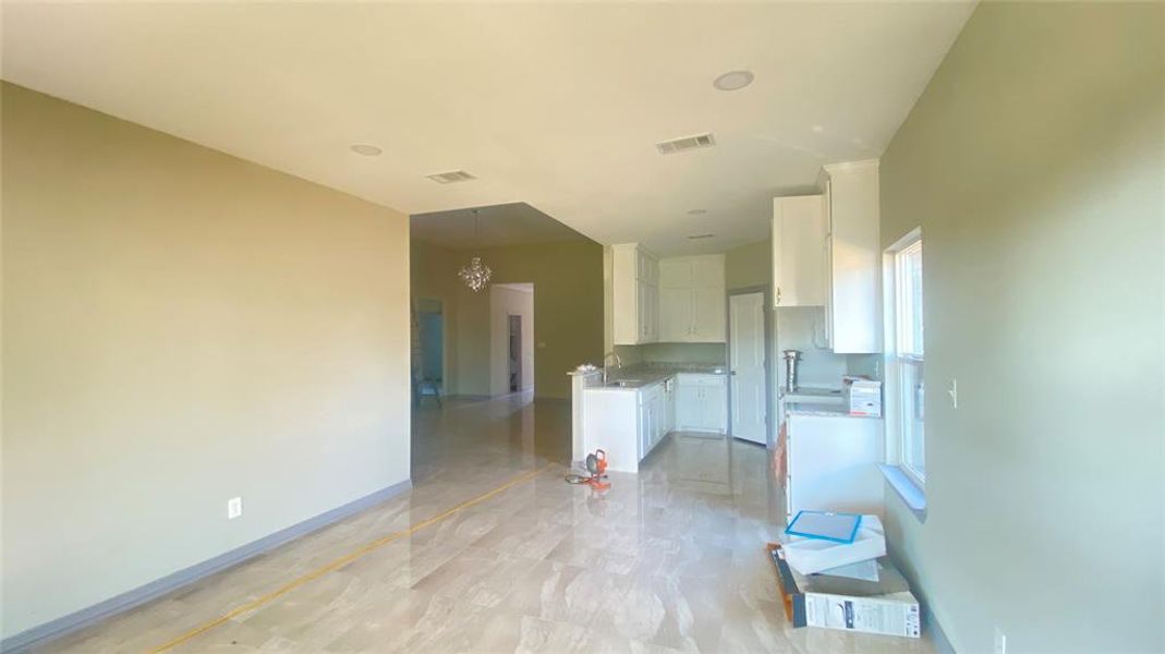 Unfurnished room featuring sink and light tile floors