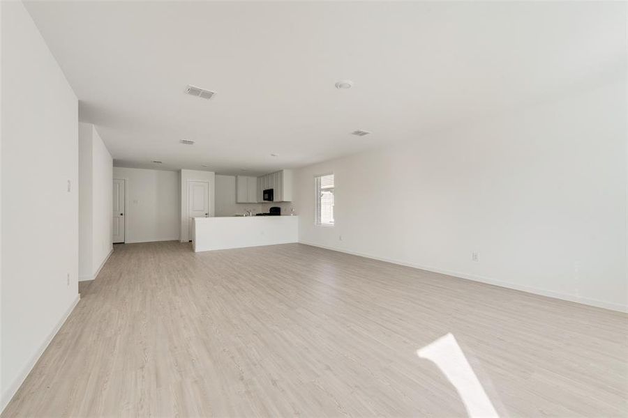 Unfurnished living room with light hardwood / wood-style floors