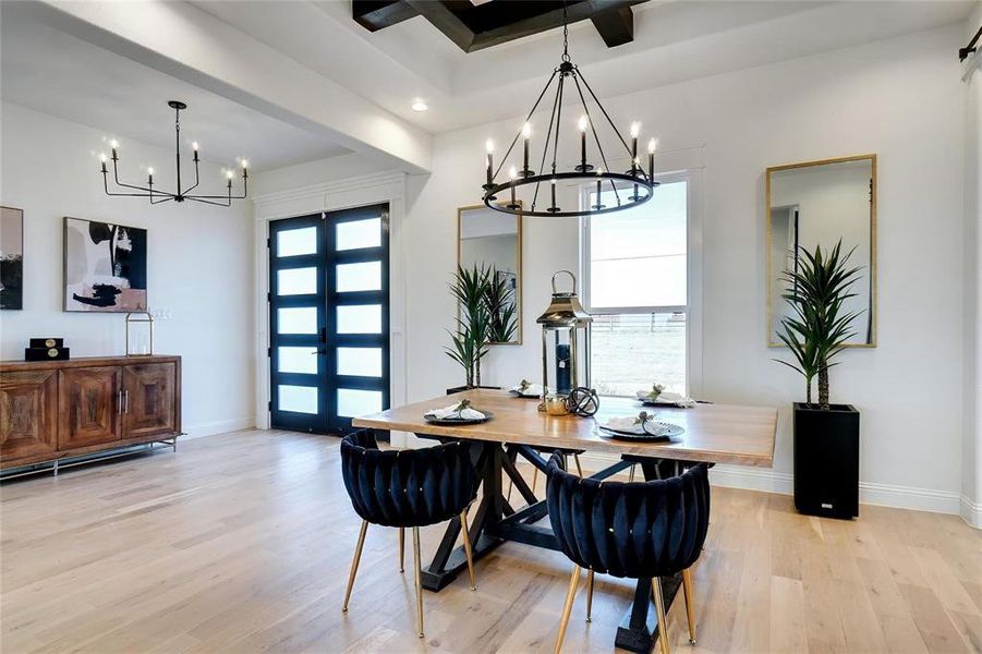 Dining area with a chandelier, light wood-style flooring, and recessed lighting