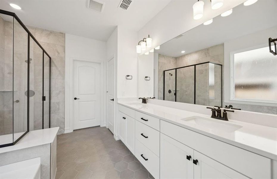 Owner's bath designed with a double vanity and oversized shower *Real home pictured Owner's bath designed with a double vanity and oversized shower *Real home pictured