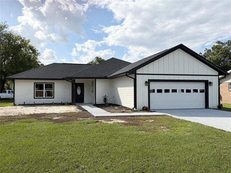 Front exterior of a new home in , Branford, FL, highlighting curb appeal (Image 1).
