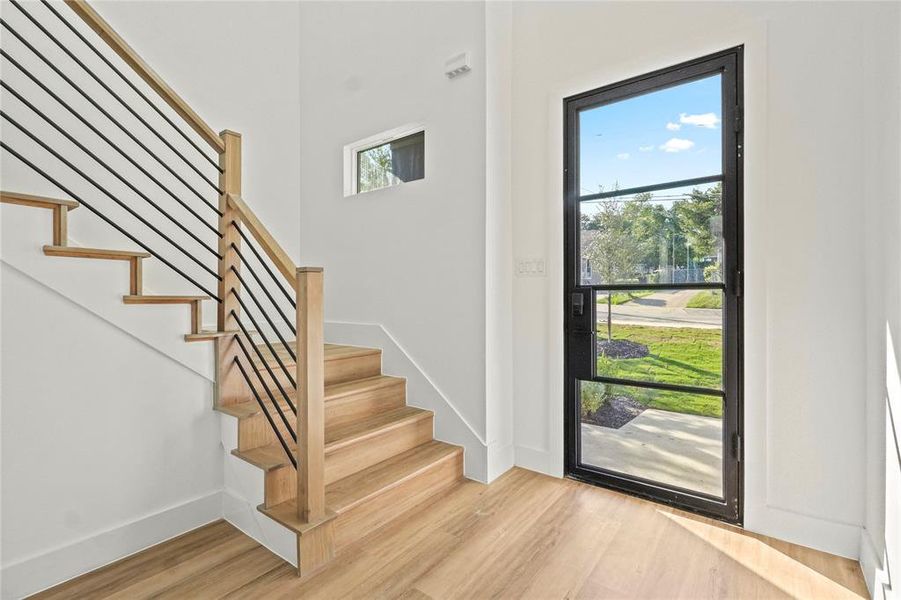 Foyer entrance featuring light wood finished floors and stairway