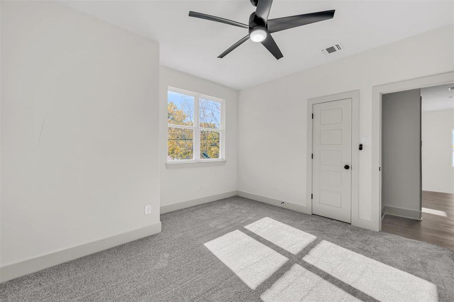 Unfurnished bedroom featuring carpet and ceiling fan