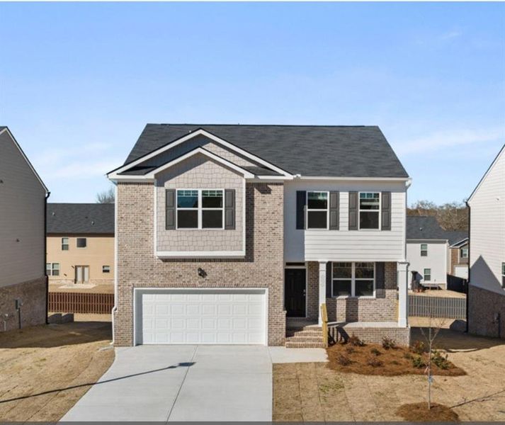 Front exterior of a new home in The Reserve at Calcutta, Stockbridge, GA, highlighting curb appeal (Image 1). Front exterior of a new home in The Reserve at Calcutta, Stockbridge, GA, highlighting curb appeal (Image 1).
