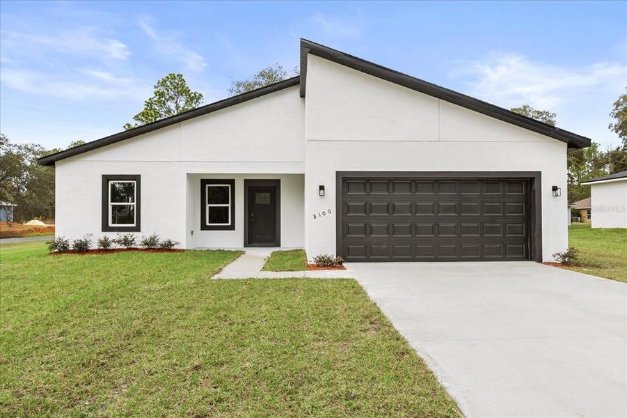 Front exterior of a new home in , Citrus Springs, FL, highlighting curb appeal (Image 1). Front exterior of a new home in , Citrus Springs, FL, highlighting curb appeal (Image 1).