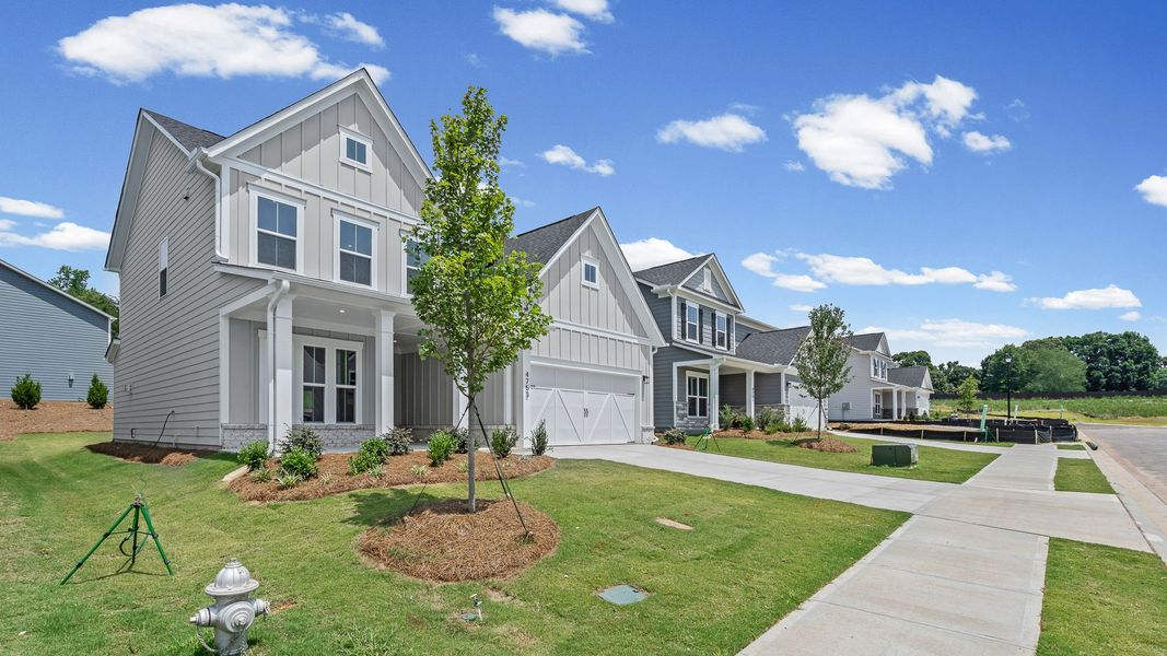 Front exterior of a new home in Hunters Creek, Flowery Branch, GA, highlighting curb appeal (Image 2). Front exterior of a new home in Hunters Creek, Flowery Branch, GA, highlighting curb appeal (Image 2).