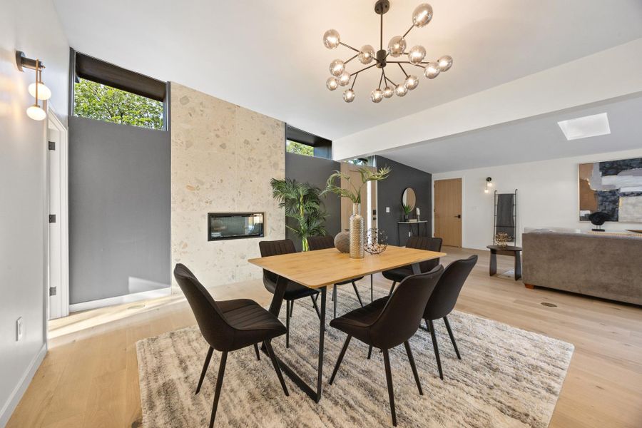 Dining space with hardwood floors and fireplace Dining space with hardwood floors and fireplace