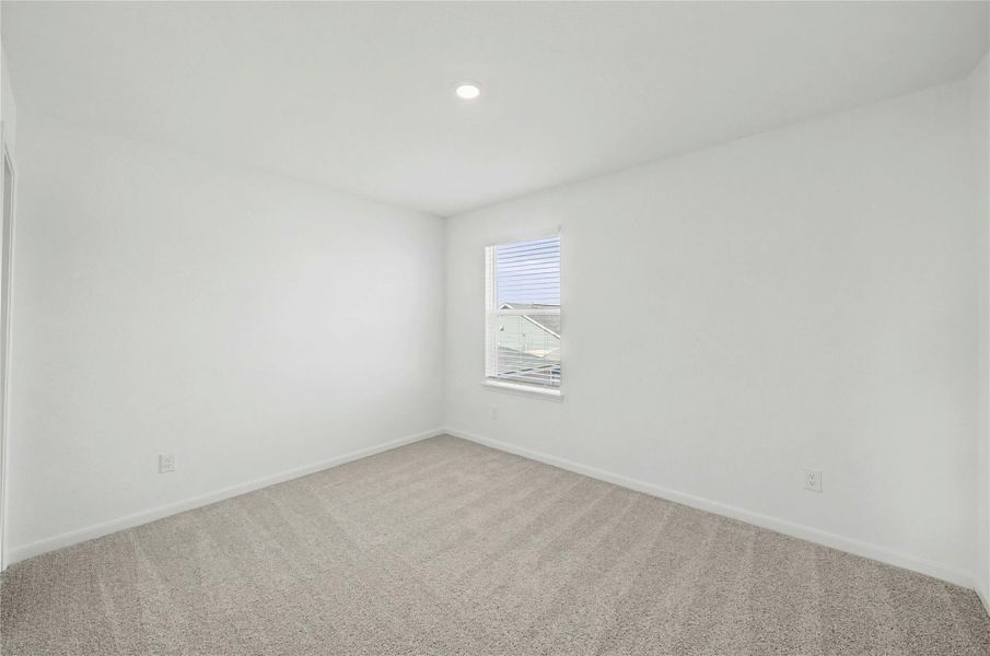 Carpeted empty room with baseboards and recessed lighting