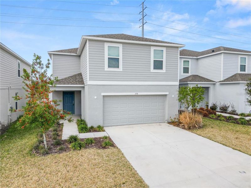 Front exterior of a new home in Marion Creek, Haines City, FL, highlighting curb appeal (Image 24). Front exterior of a new home in Marion Creek, Haines City, FL, highlighting curb appeal (Image 24).