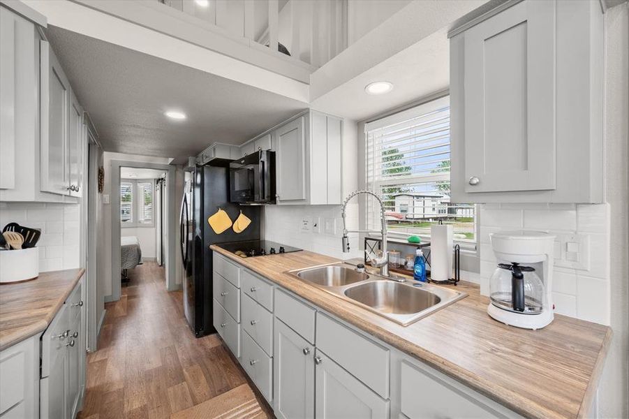 This kitchen area features a TON of cabinetry, which will keep your compact space neat and tidy.