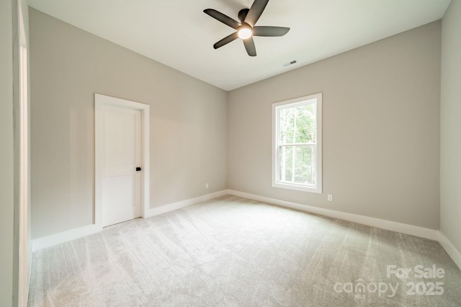 Spacious Bedroom 2 on the Main Level with a Walk-in Closet overlooking Lake Norman