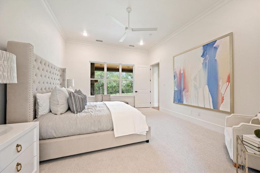 Bedroom featuring light colored carpet, crown molding, and ceiling fan