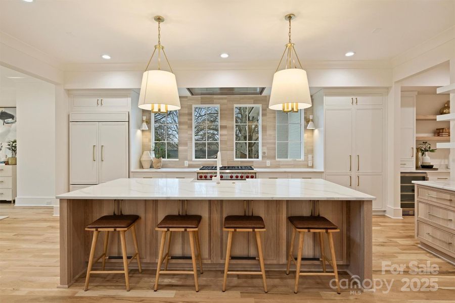 The gourmet kitchen is a chef's dream, complete with an oversized island and quartz countertops.