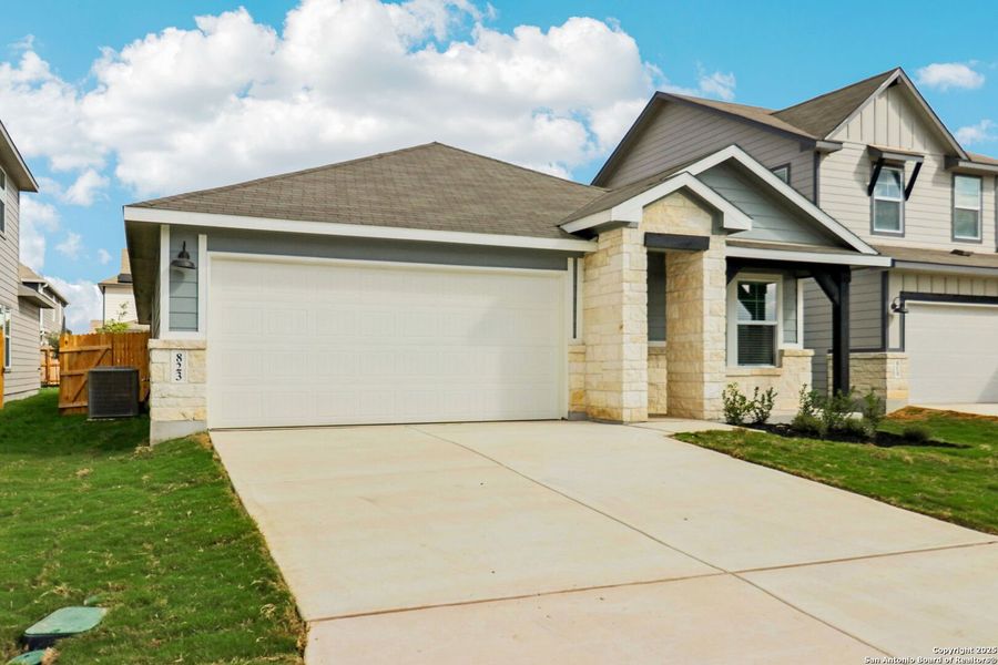 Front exterior of a new home in Estancia Ranch - Premier Series, San Antonio, TX, highlighting curb appeal (Image 1).