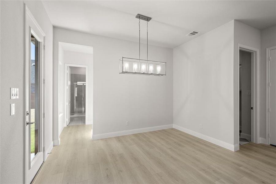 Unfurnished dining area with light hardwood / wood-style flooring