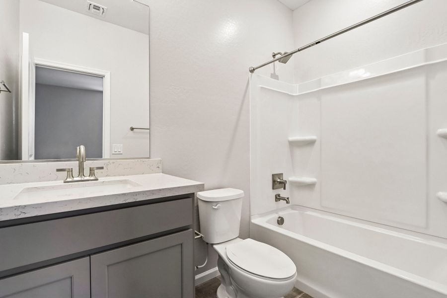 A bathroom with a tub toilet and sink.