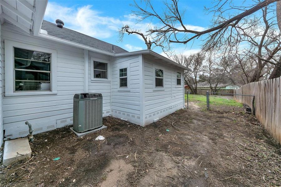 View of home's exterior with a shingled roof and crawl space View of home's exterior with a shingled roof and crawl space