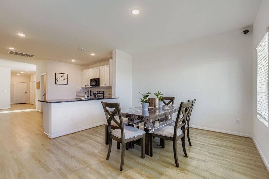 Dining space featuring light wood-style floors and recessed lighting