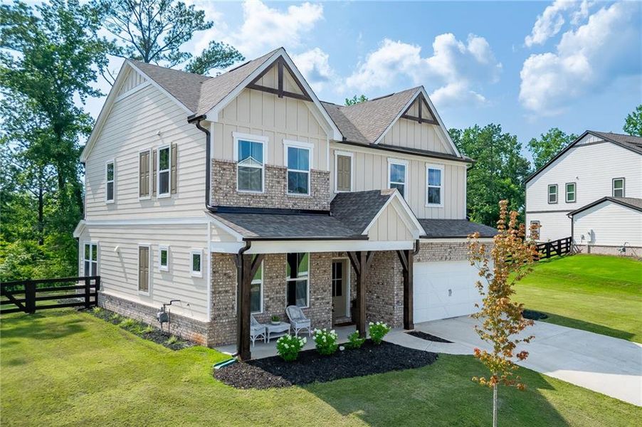 Front exterior of a new home in Tiberon Woods, Cumming, GA, highlighting curb appeal (Image 2). Front exterior of a new home in Tiberon Woods, Cumming, GA, highlighting curb appeal (Image 2).