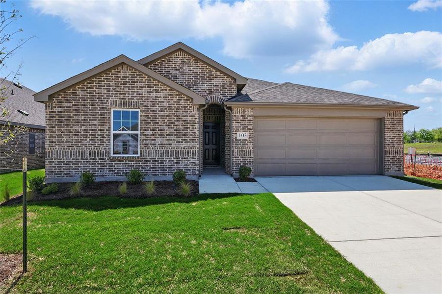 View of front of house featuring brick siding, concrete driveway, a front lawn, an attached garage, and roof with shingles