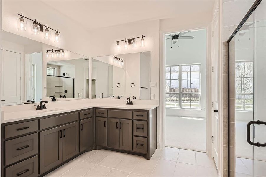 Bathroom featuring walk in shower, vanity, tile patterned flooring, and ceiling fan