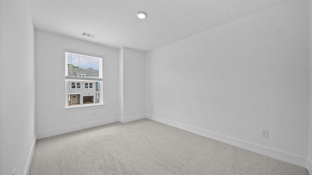 Carpeted bedroom in two story townhome at Ransdell Pointe by DRB Homes in Spartanburg, SC