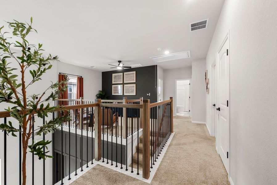 Hall featuring an upstairs landing, light carpet, and recessed lighting