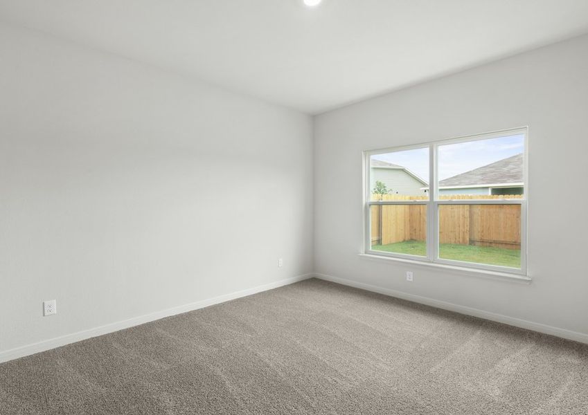 The master bedroom is spacious and has a wonderful window.