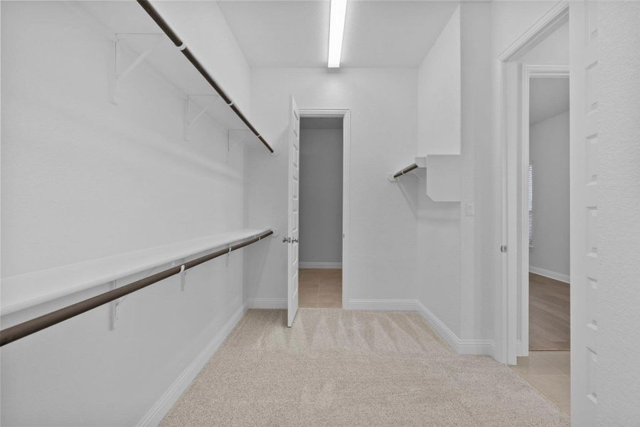 Walk-in closet in Primary Bedroom Walk-in closet in Primary Bedroom