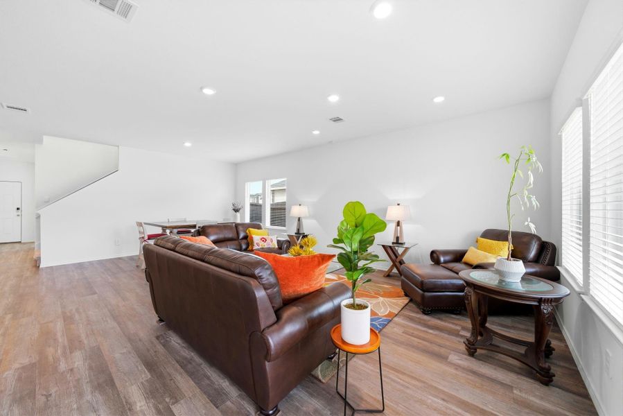 Spacious living room bathed in natural light, with a warm, welcoming vibe that's perfect for gatherings.