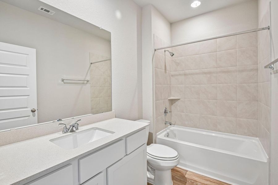 The secondary bathroom offers a clean, functional layout with modern fixtures and durable finishes designed for everyday use.