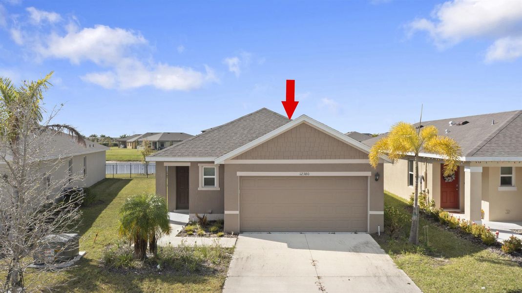 Front exterior of a new home in Central Park 40s, Port St. Lucie, FL, highlighting curb appeal (Image 1).