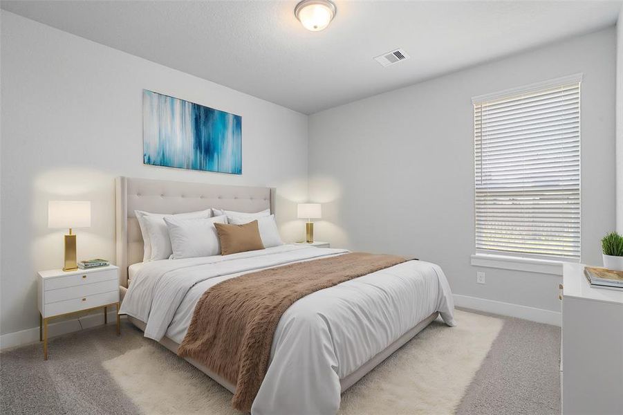 Secondary bedroom features plush carpet, custom paint and a large window with privacy blinds.