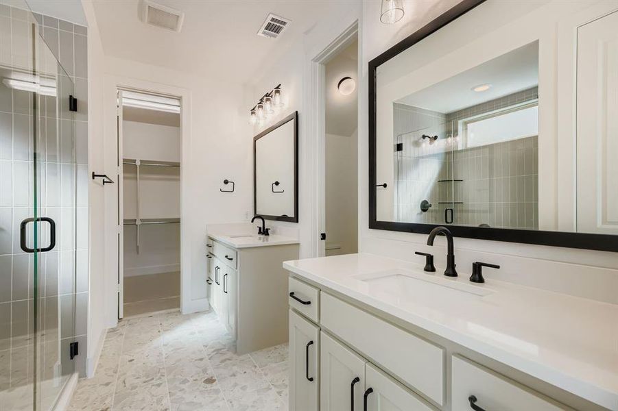 Bathroom with a stall shower, two vanities, and a spacious closet Bathroom with a stall shower, two vanities, and a spacious closet