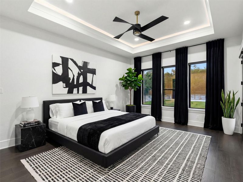Virtually Staged Primary Bedroom featuring dark wood-style flooring, a ceiling fan, a tray ceiling, and recessed lighting