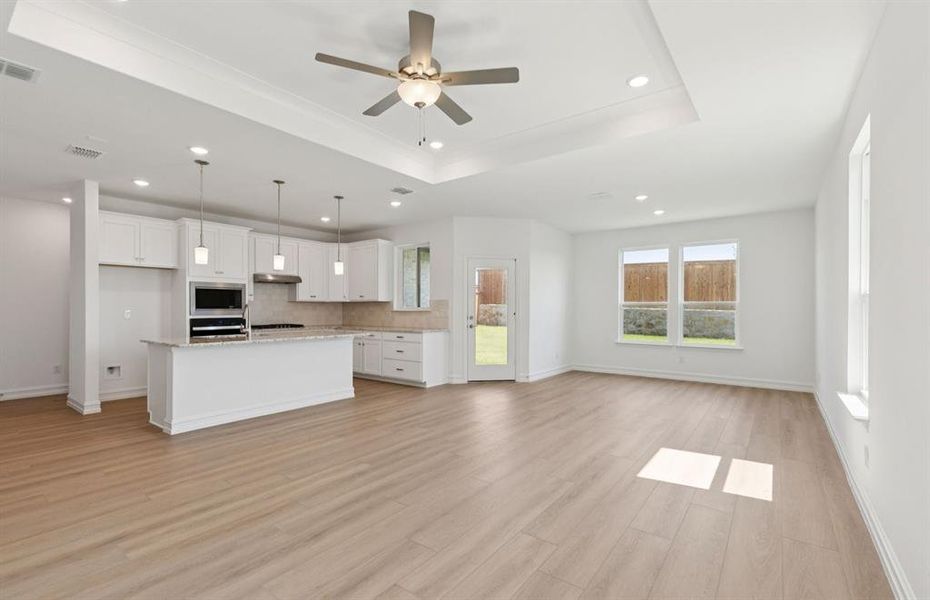 Expansive gathering room bathed in natural sunlight  *Real home pictured